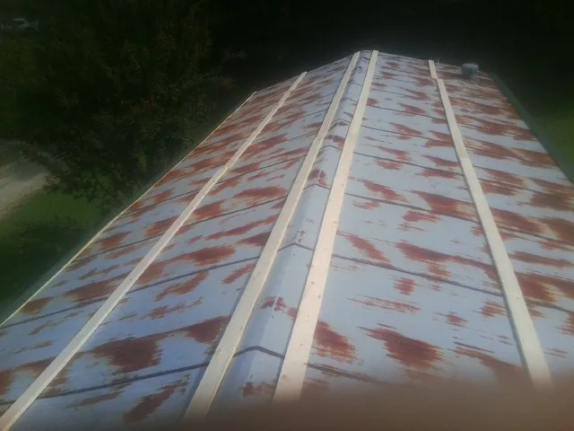 Rusted metal roof panels with new wood purlins before replacement — Storm Damage Roof Repair in Allen Park by Roofing Brothers